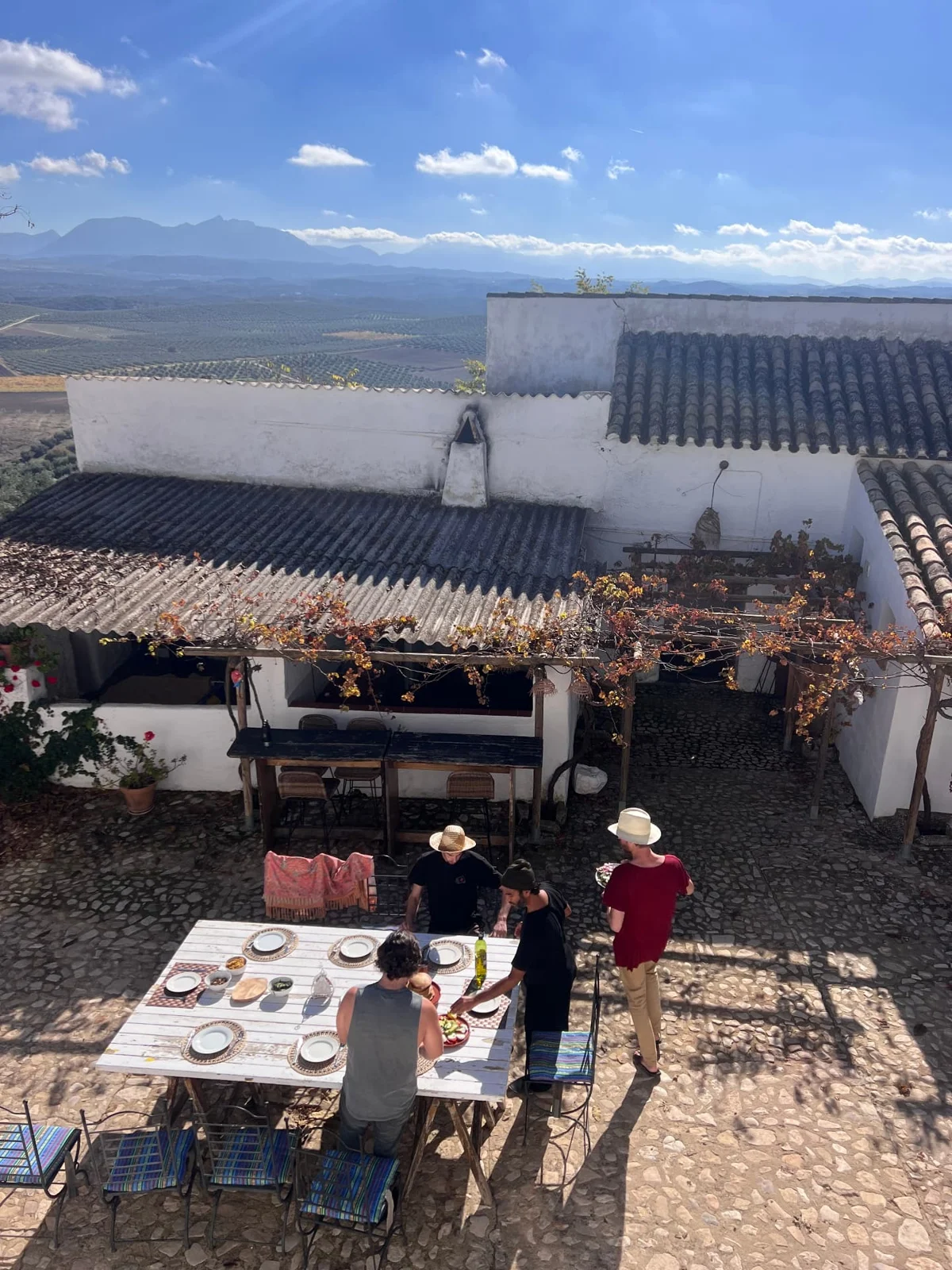 Preparing a shared lunch in the sunlit stone courtyard