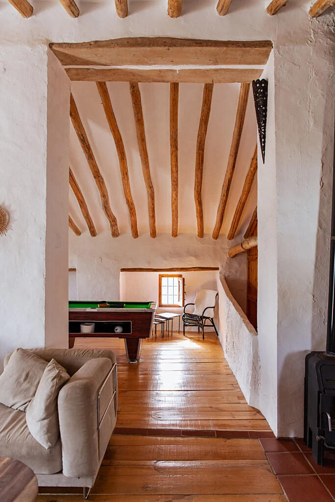 Beamed upstairs landing with a pool table and warm wooden floor