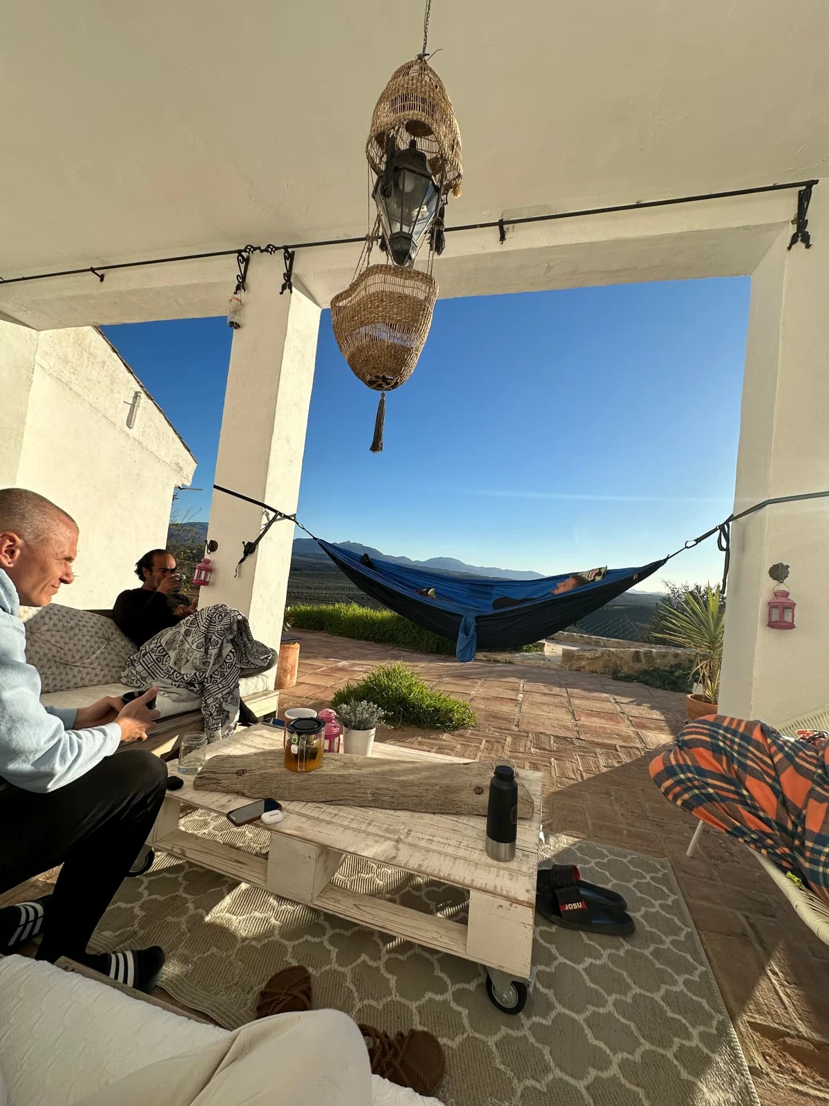 Relaxing on the covered terrace beside a hammock with mountain views